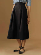 Front view of Wynona Black plain poplin skirt by Thierry Colson
