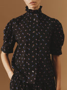 Close-up of Vita black blouse from Pre Spring 2024 by Thierry Colson