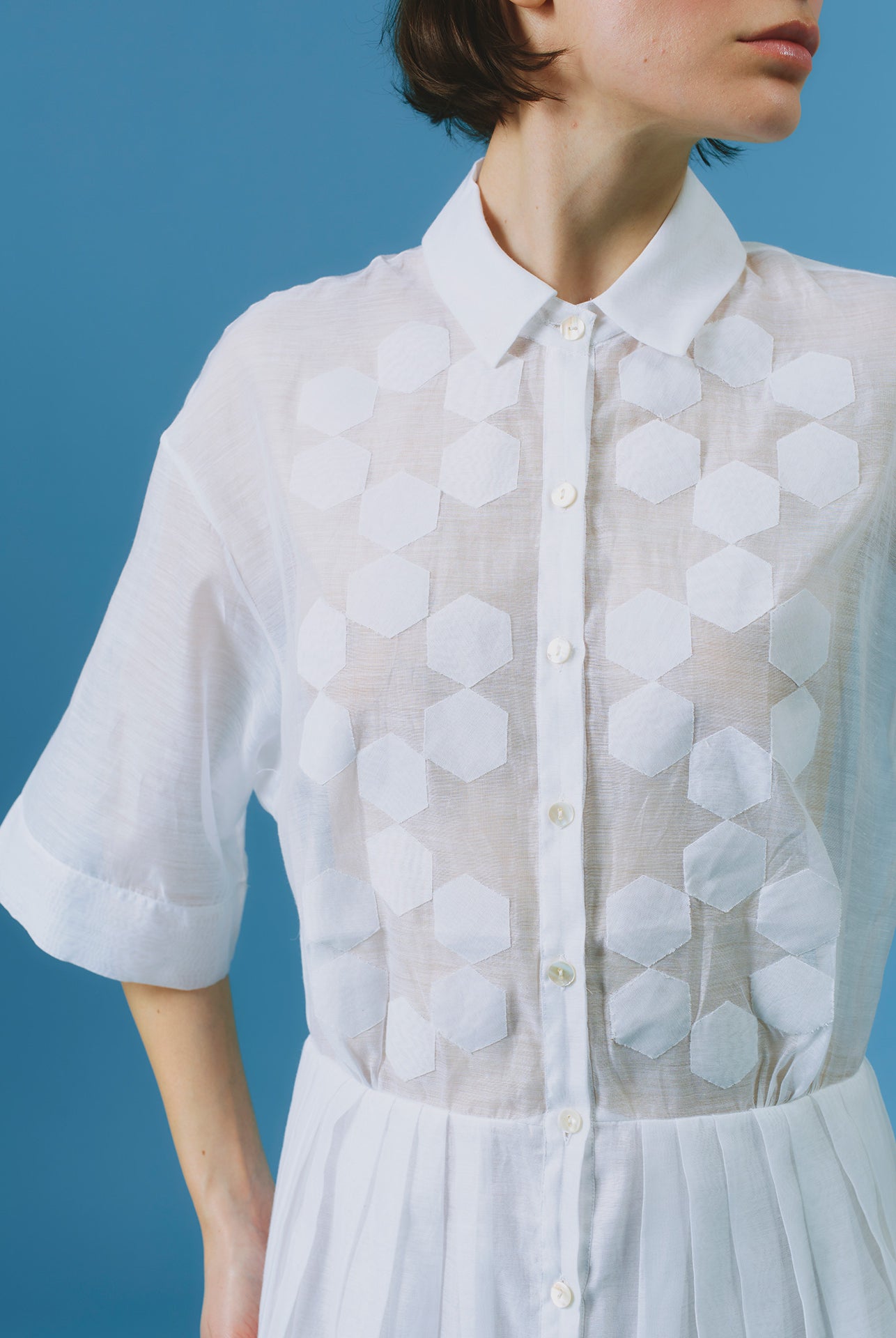 Close up of Oriane white knee dress by Thierry Colson