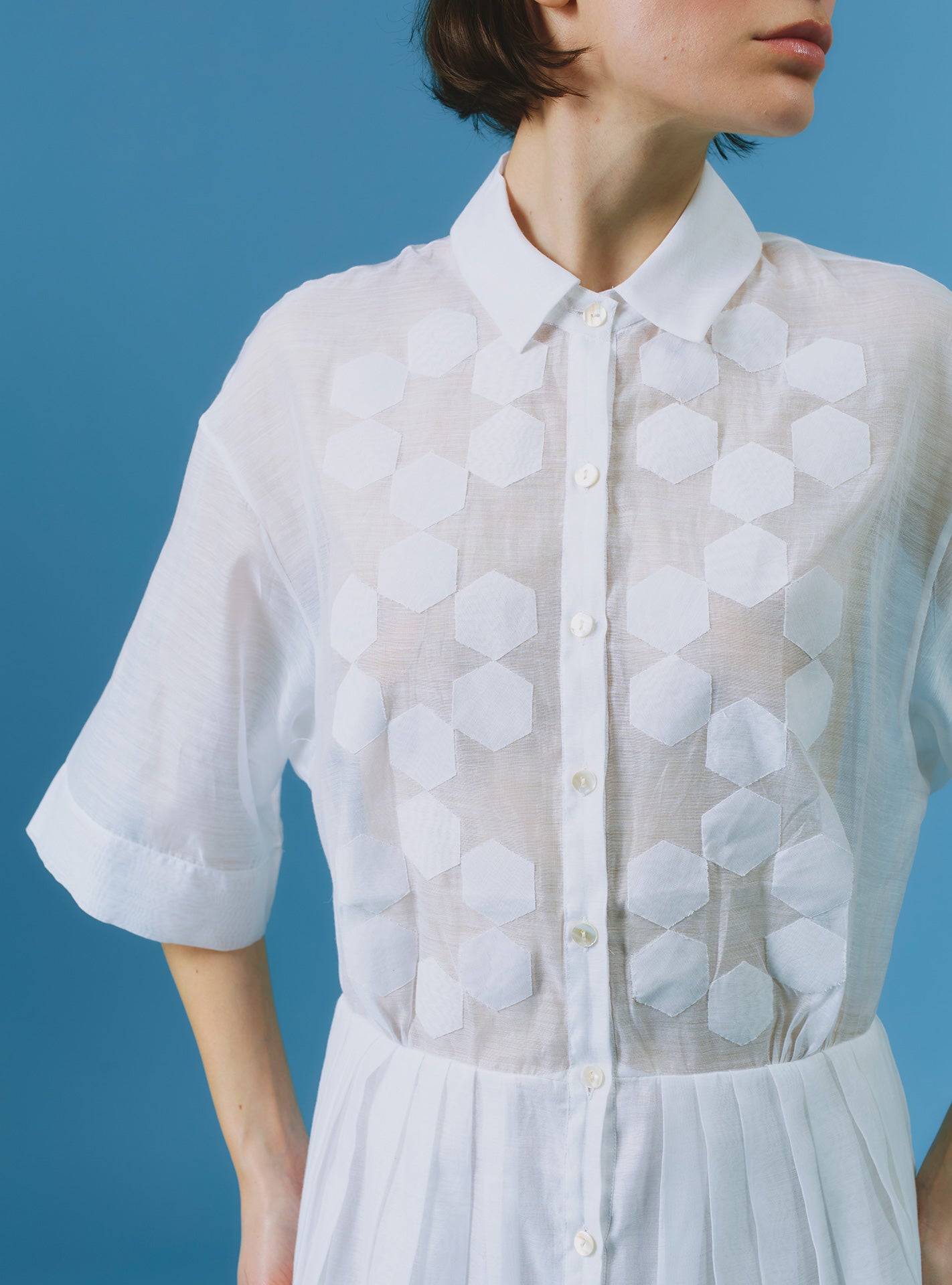 Close up of Oriane white knee dress by Thierry Colson