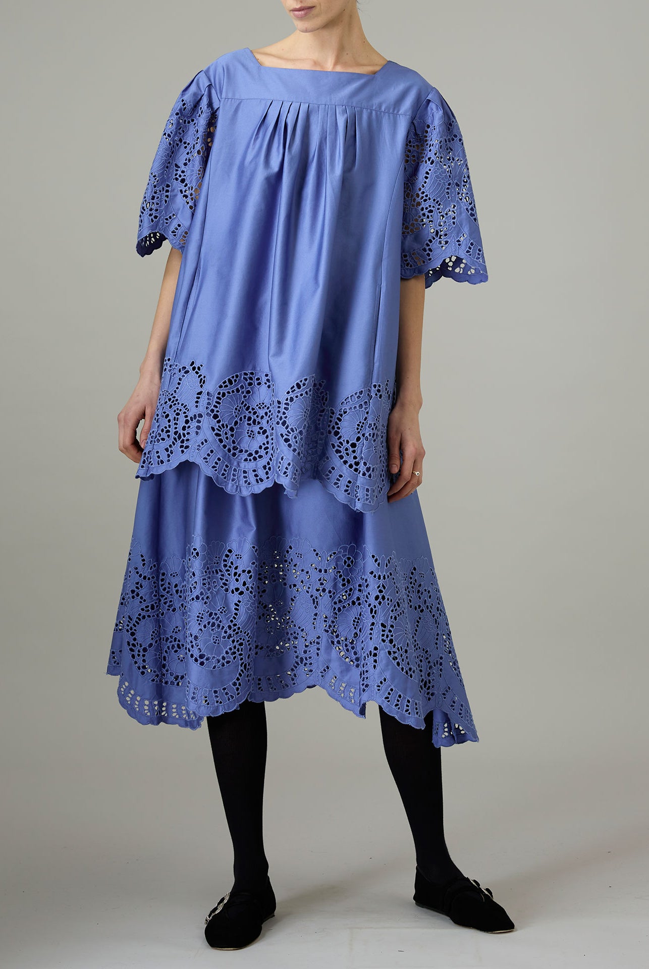 Blue dress with lace details on a plain background