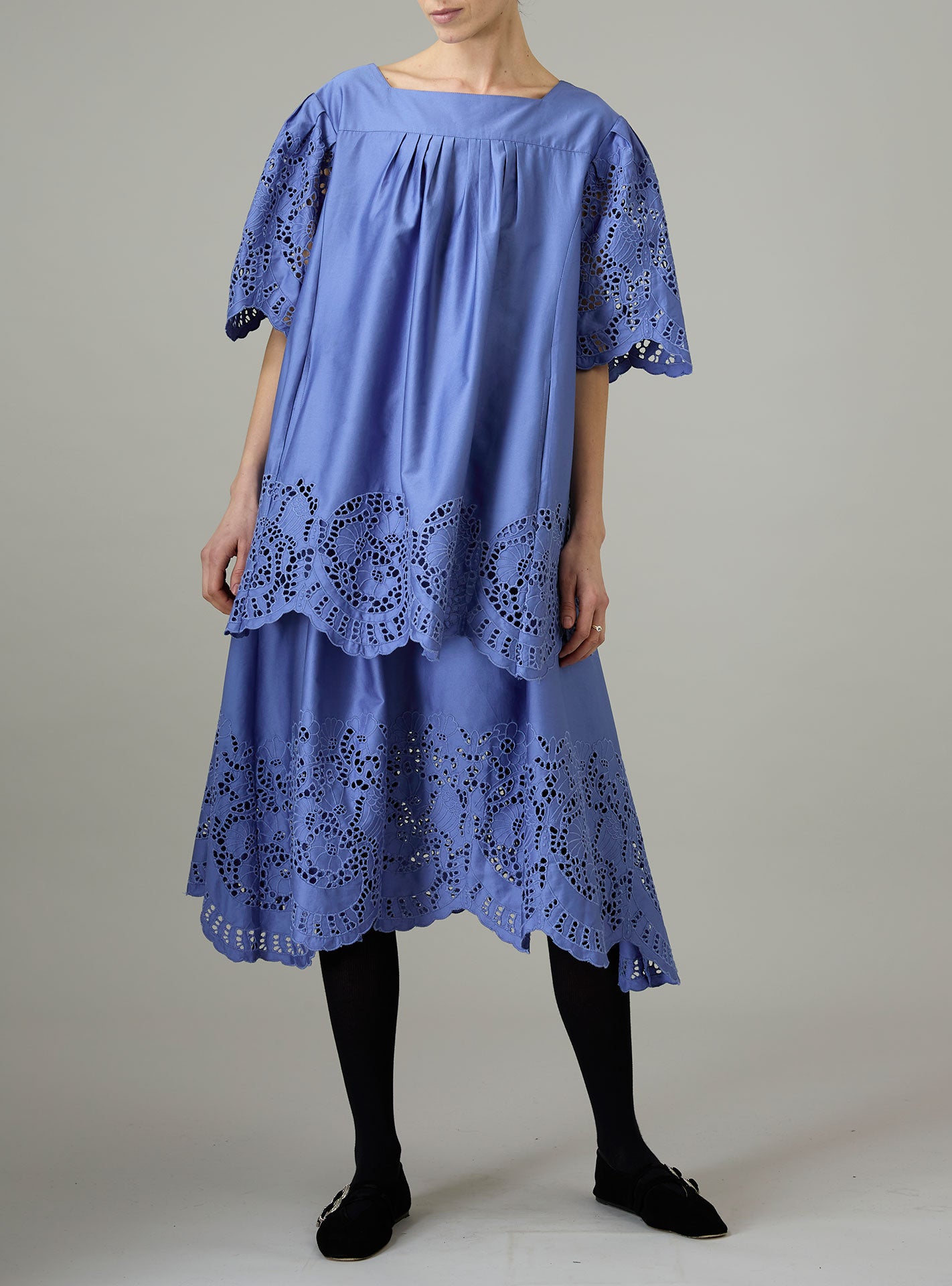 Blue dress with lace details on a plain background