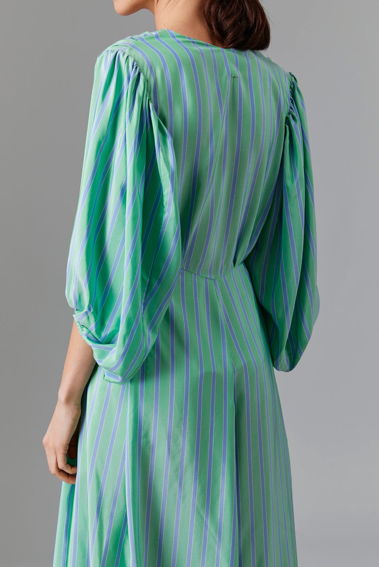 Close up back view of Phoebe Long Dress - Silk Road Stripes in Green/Blue | Thierry Colson Fall 2024 Collection