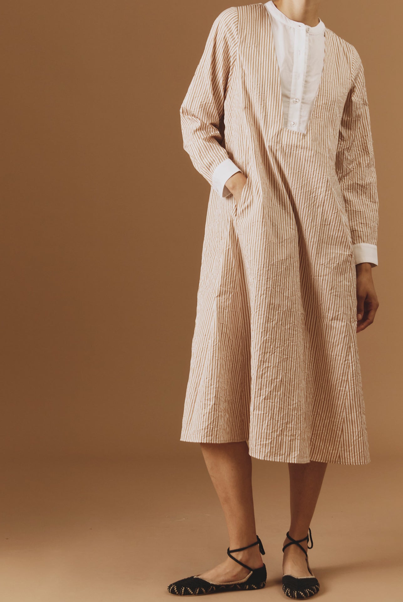 Front view of Victoria Cappuccino Midi Crinkle satin kaftan by Thierry Colson - hand in the pocket