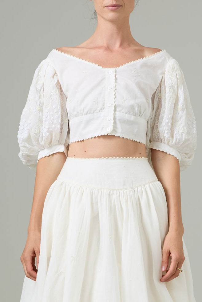 White off-shoulder top and skirt set on a neutral background
