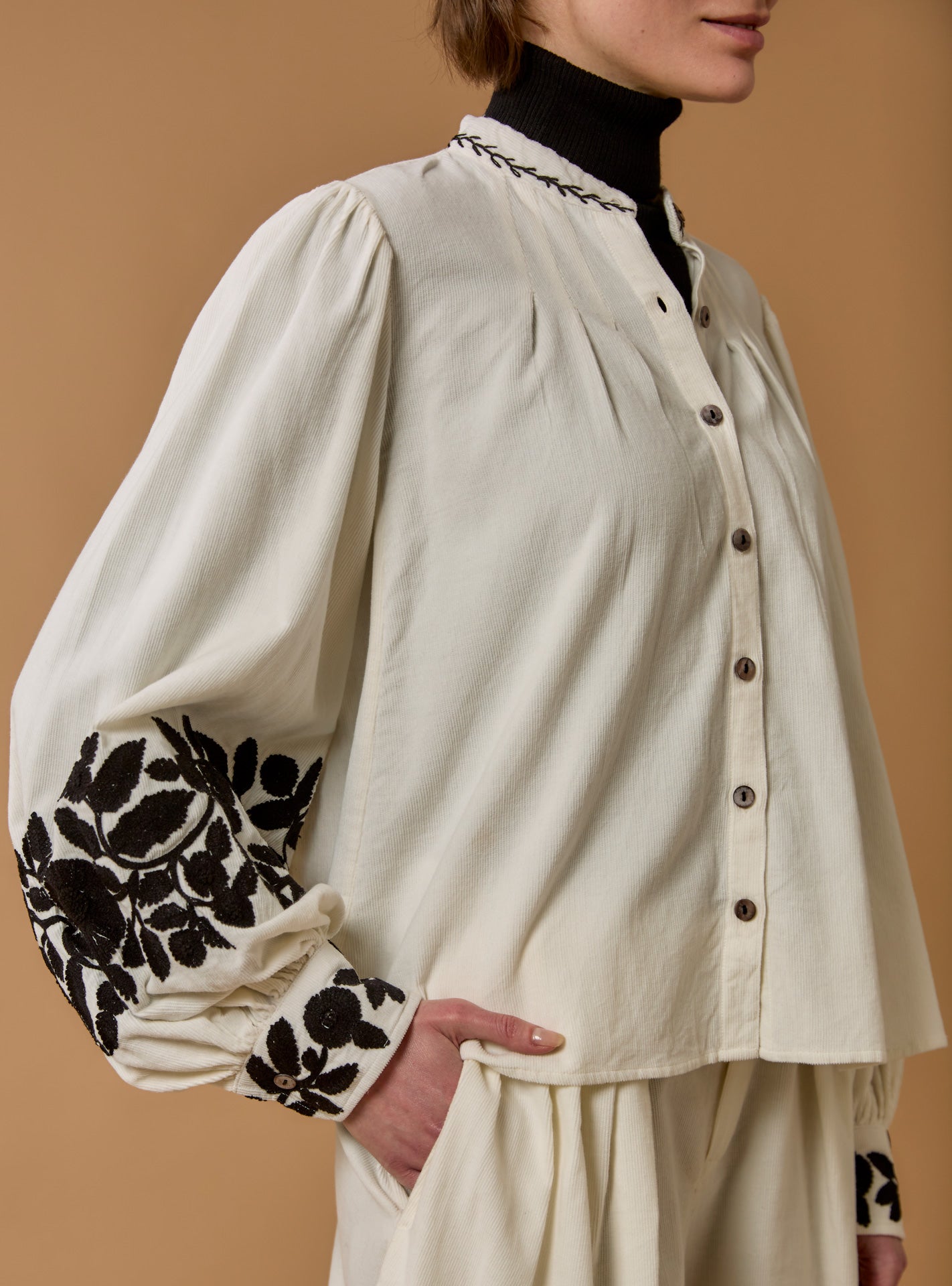 Close-up of Yana corduroy Cream Blouse with black embroidered by Thierry Colson