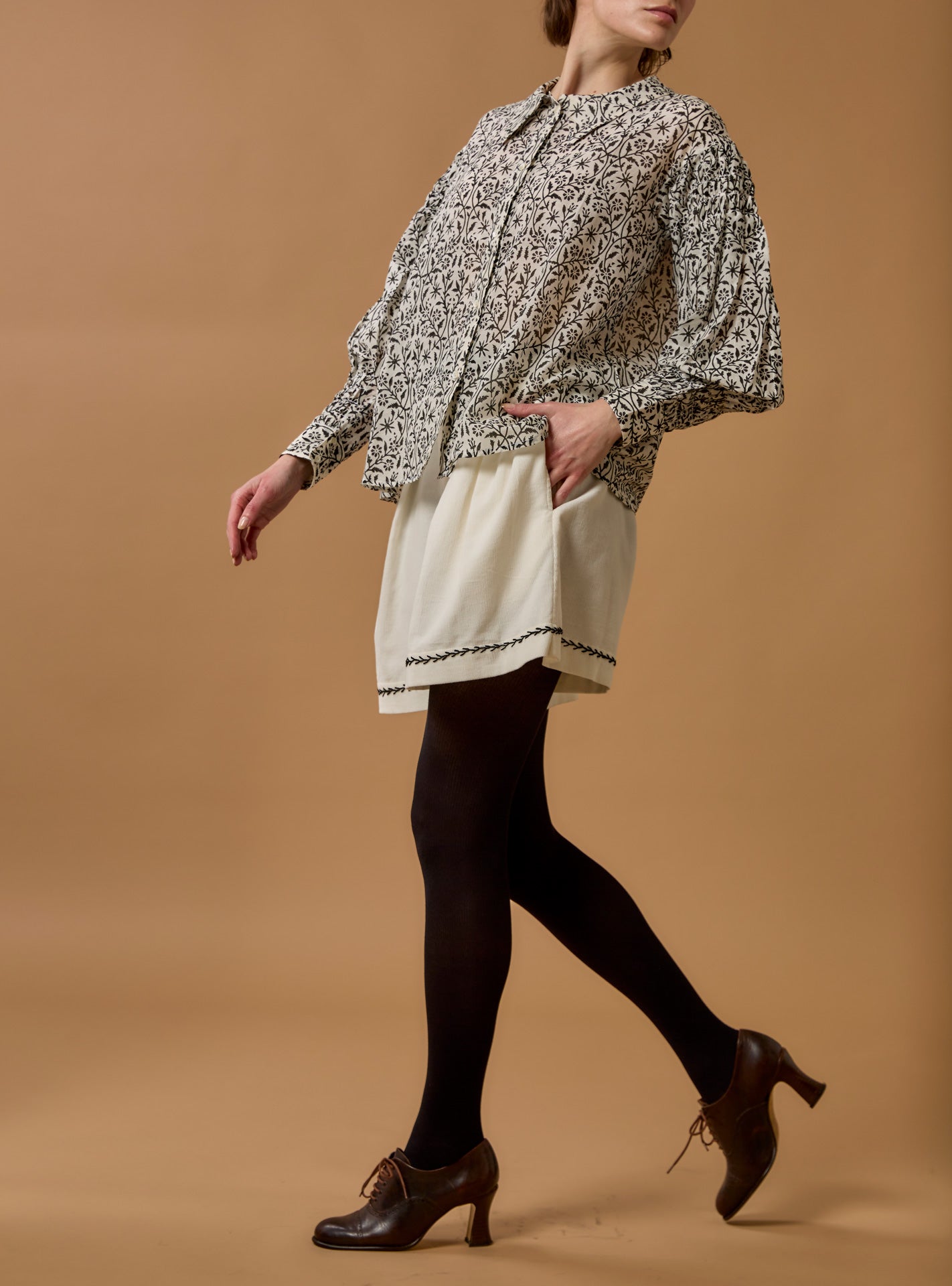 Front view of Zlata Black Blouse - Paper Cut Print by Thierry Colson with a Kenya Short