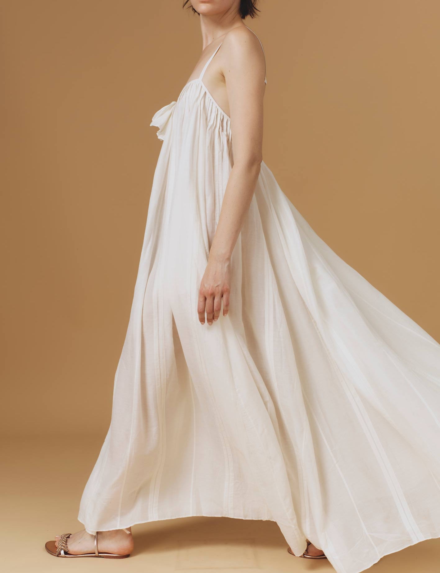 Side of Zenobia Optical Pleats Off White long dress by Thierry Colson