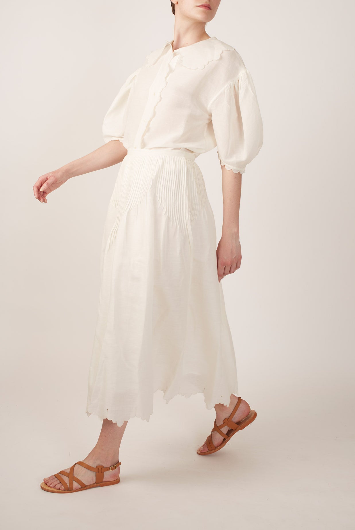 Side view of Vanina Barocco Scallops Off White Blouse with Verde Skirt by Thierry Colson