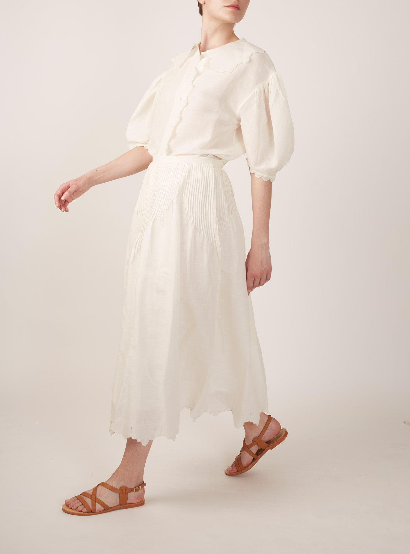 Side view of Vanina Barocco Scallops Off White Blouse with Verde Skirt by Thierry Colson