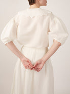Back view of Vanina Barocco Scallops Off White Blouse by Thierry Colson