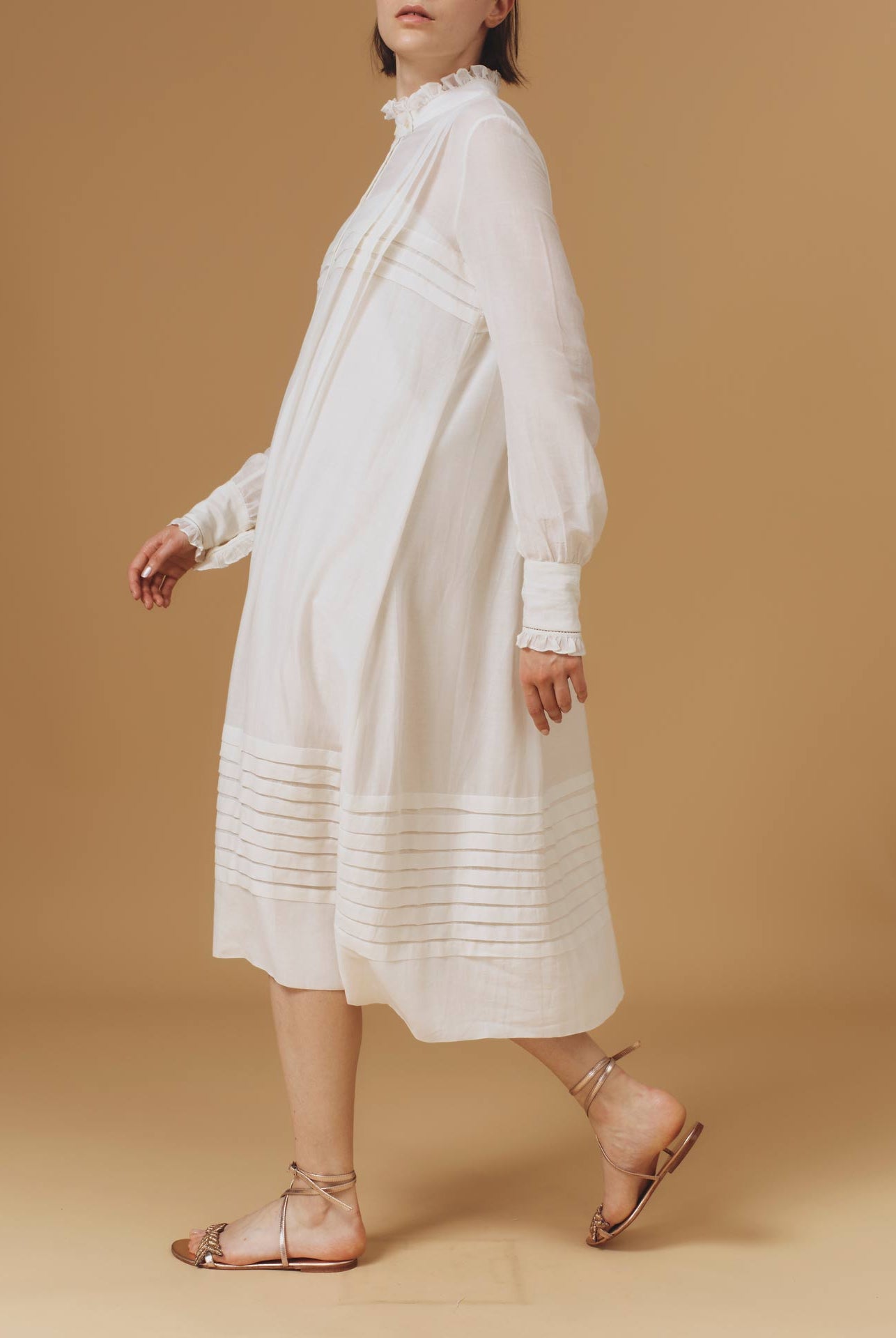 Side of Zita Optical Pleats Off White dress by Thierry Colson