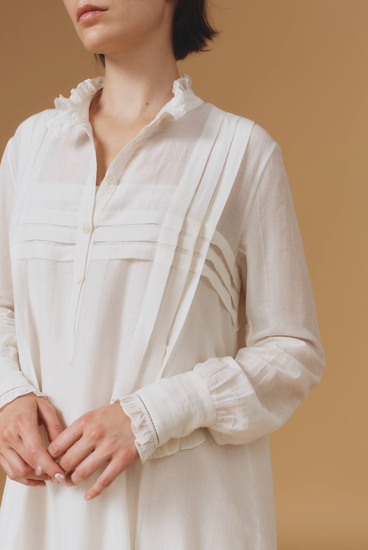 Close up Front view of Zita Optical Pleats Off White dress by Thierry Colson
