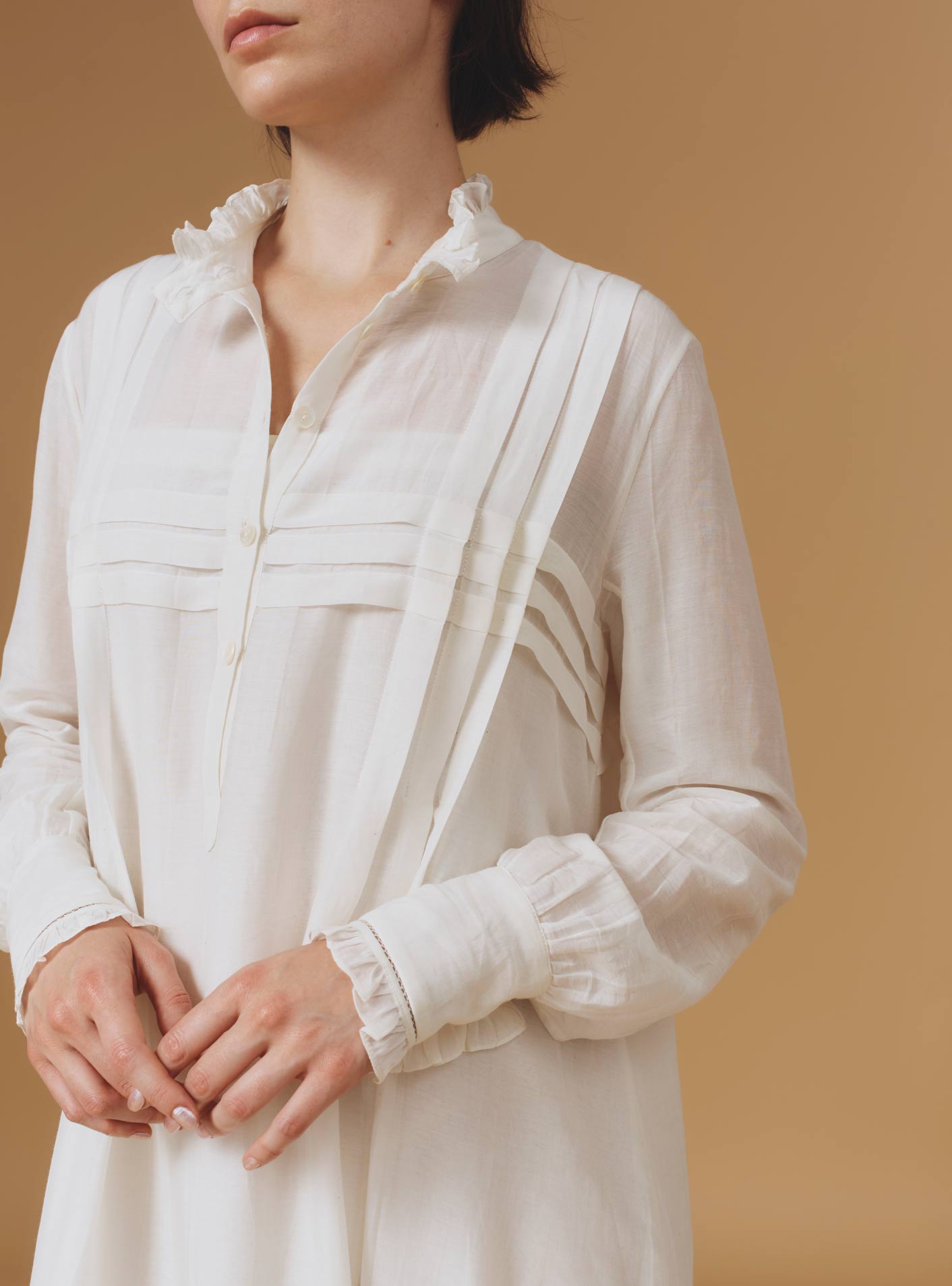 Close up Front view of Zita Optical Pleats Off White dress by Thierry Colson