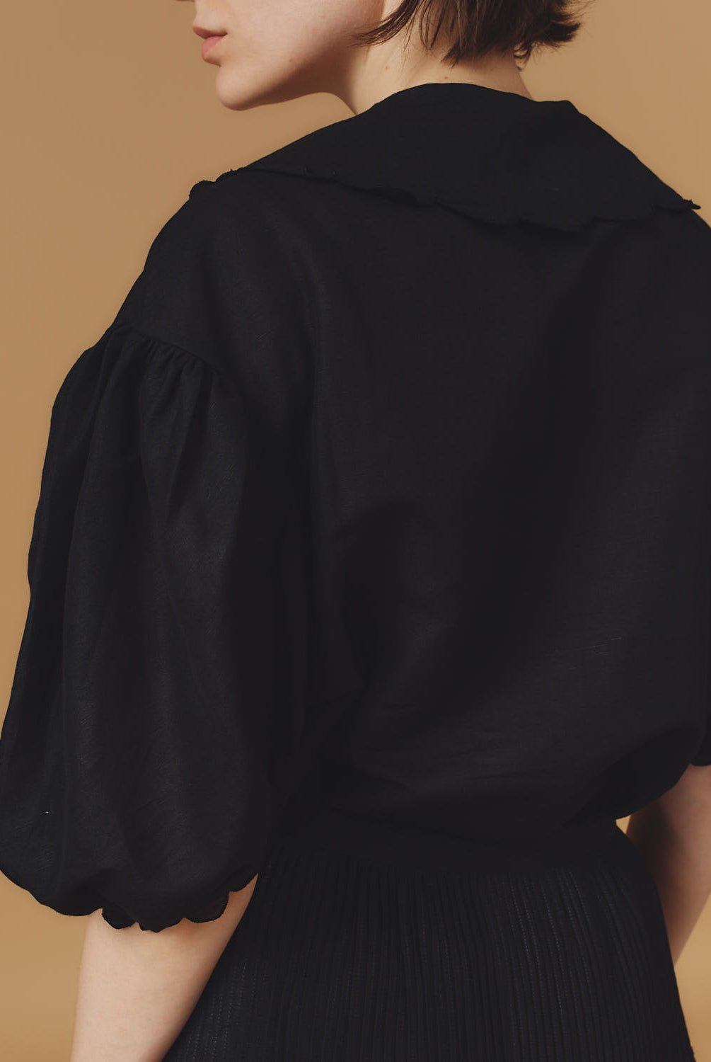 Back view of Vanina Barocco Scallops Black Blouse by Thierry Colson