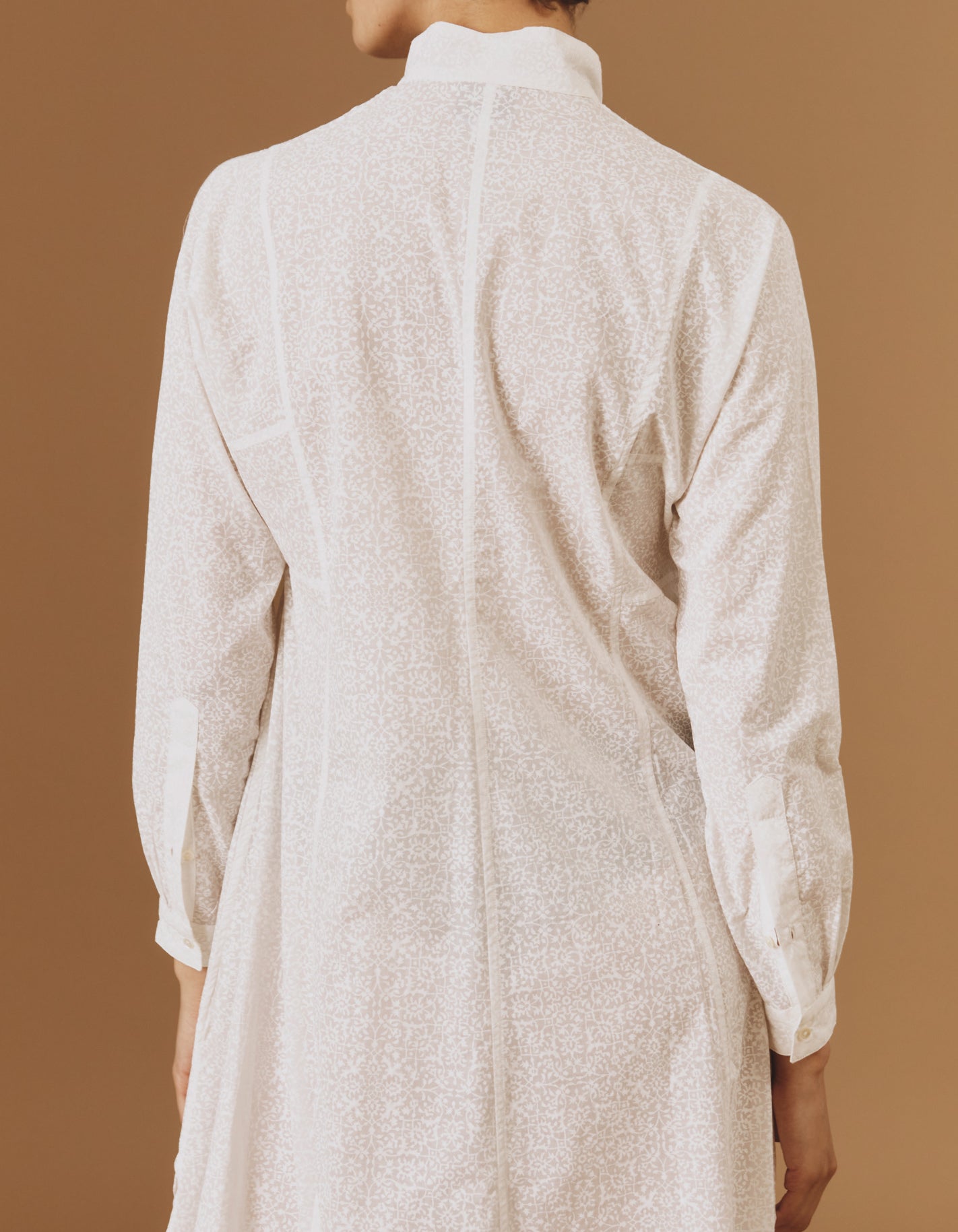 Close up back view of Parvati white on white long Kaftan by Thierry Colson