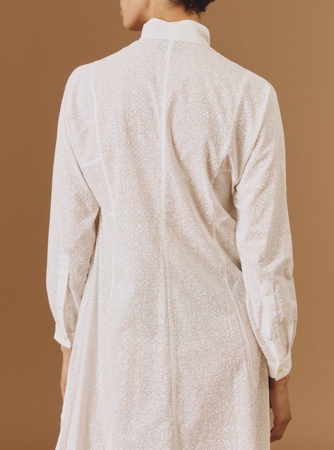 Close up back view of Parvati white on white long Kaftan by Thierry Colson