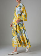 Side view of Almudena kaftan kimono dress in yellow and storm blue mimosa-inspired Garden of Eden print. Thierry Colson PS25