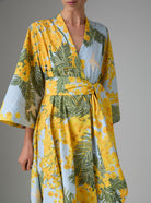 Detail of Almudena kaftan kimono dress in yellow and storm blue mimosa-inspired Garden of Eden print. Thierry Colson PS25