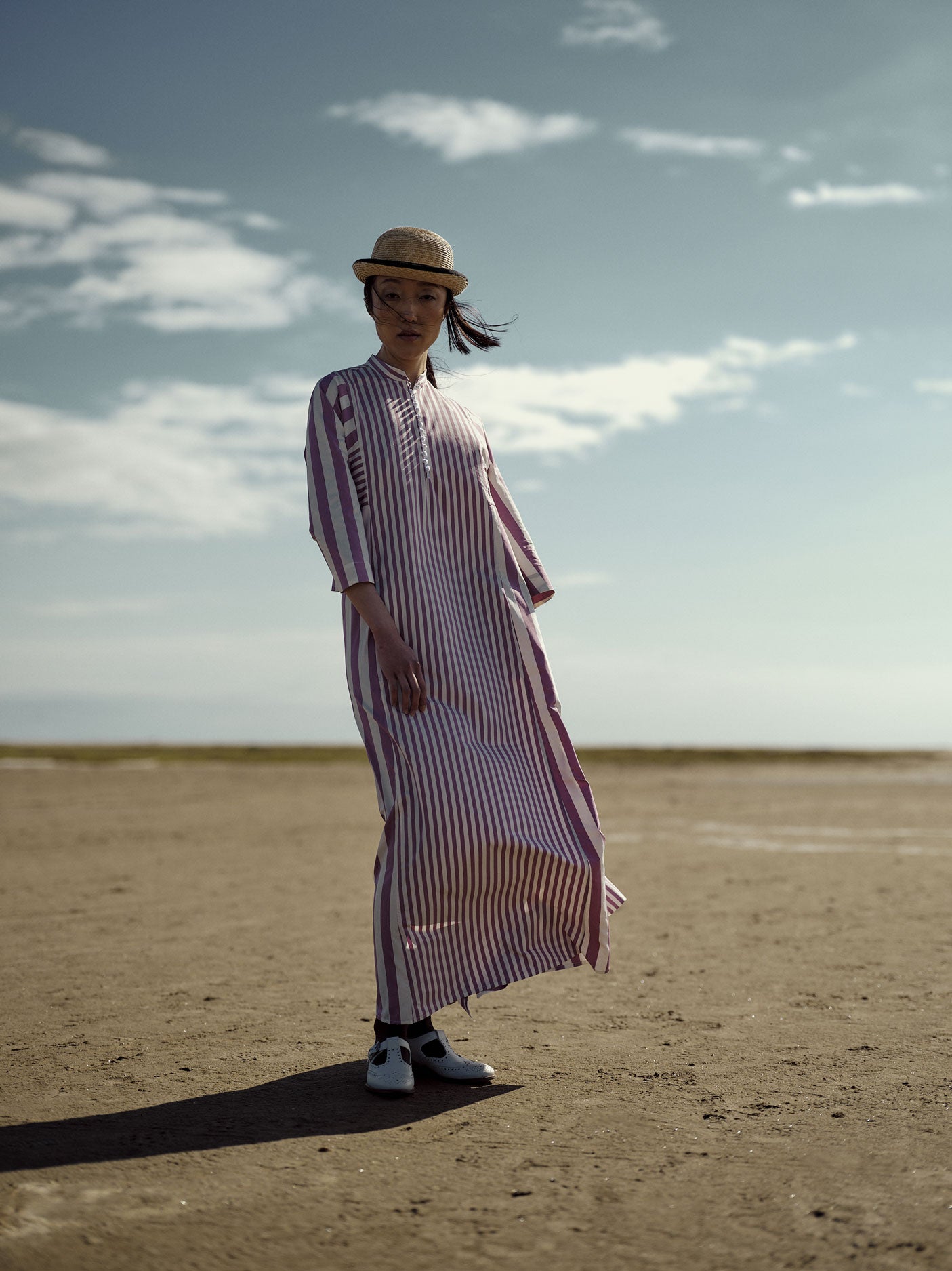 Model wearing the Rachel Long Kaftan in Cyclamen with bold stripe patterns by Thierry Colson