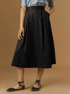Front view of Wynona Black cotton skirt with pockets by Thierry Colson