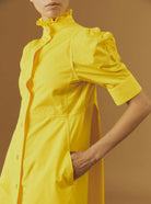Close-up of Venetia Yellow luxury cotton dress by Thierry Colson