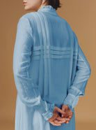 Close up back view of Zita Optical Pleats Heaven Blue dress by Thierry Colson