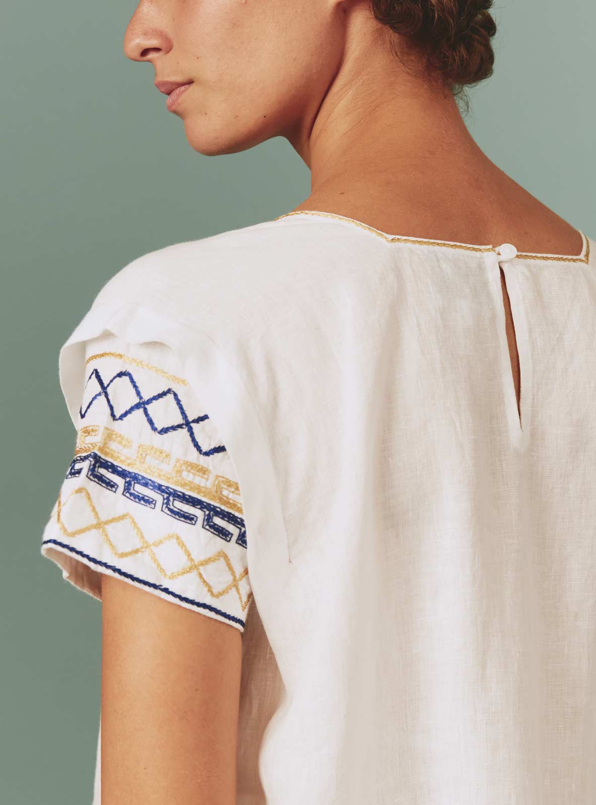 Back detail view of Allison Mini Dress: Archaic Embroidery in White by Thierry Colson