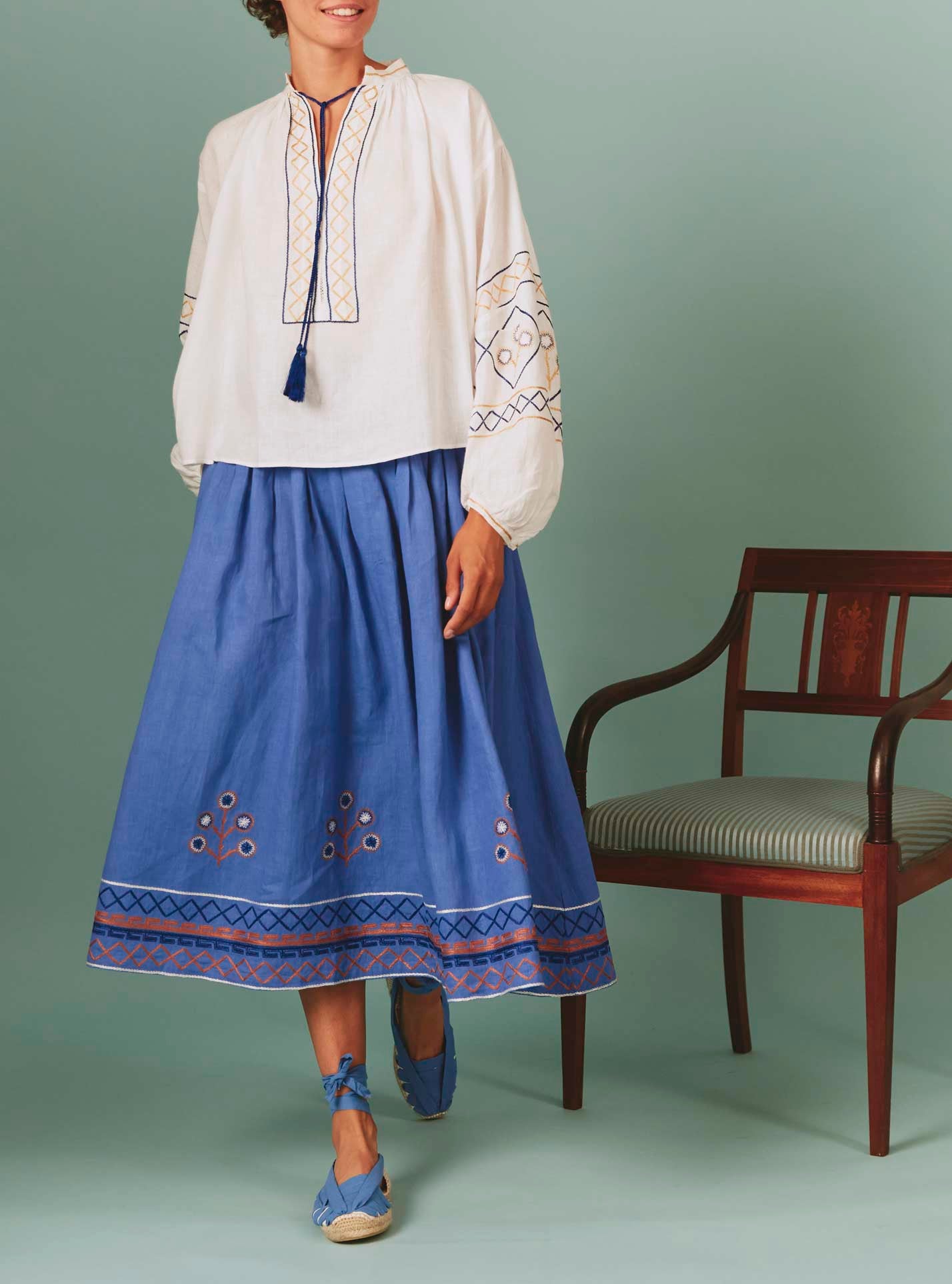 Front view Guise Blouse with Archaic Embroidery in White by Thierry Colson, with Zazou skirt in blue lavender
