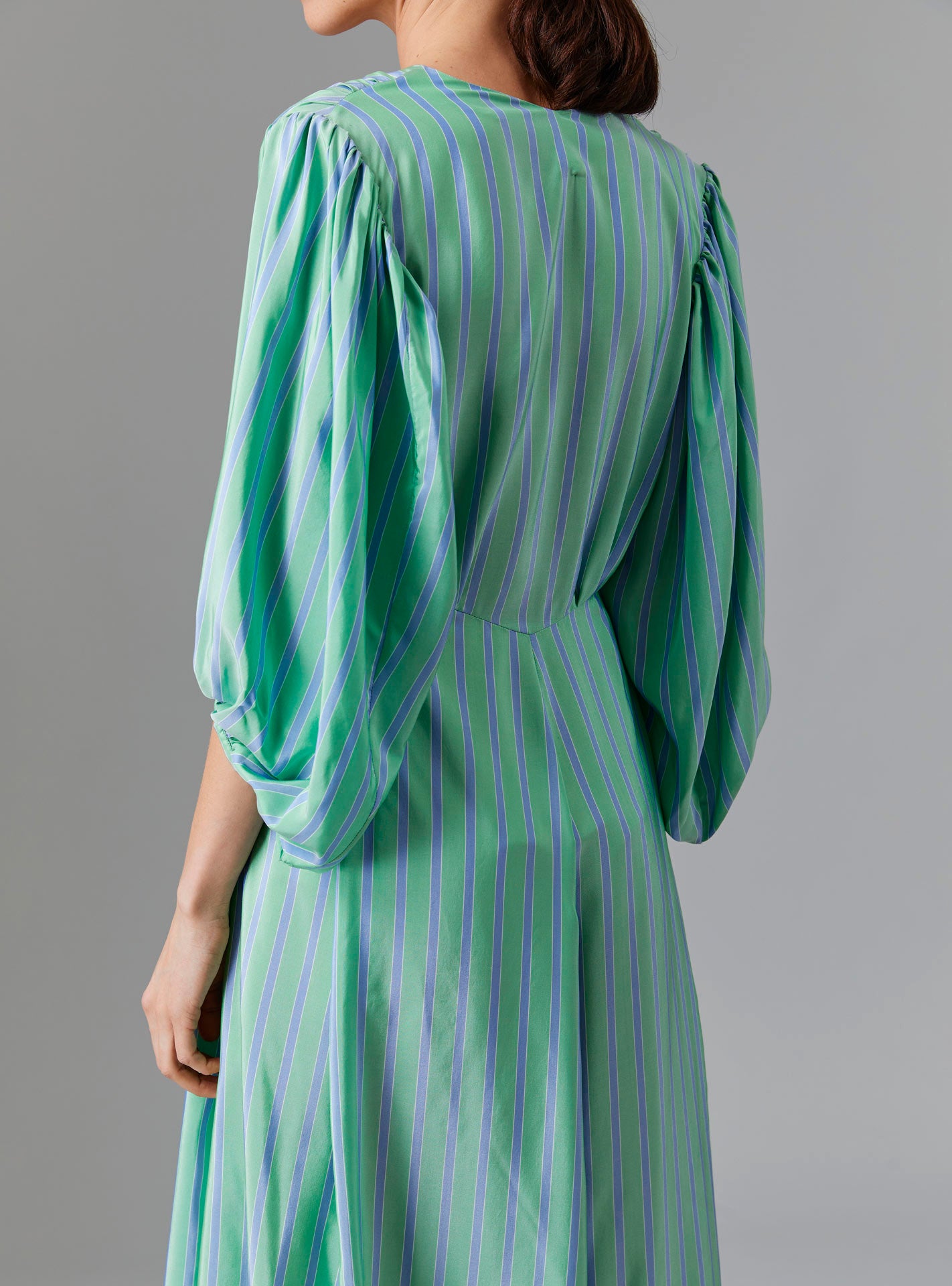 Close up back view of Phoebe Long Dress - Silk Road Stripes in Green/Blue | Thierry Colson Fall 2024 Collection