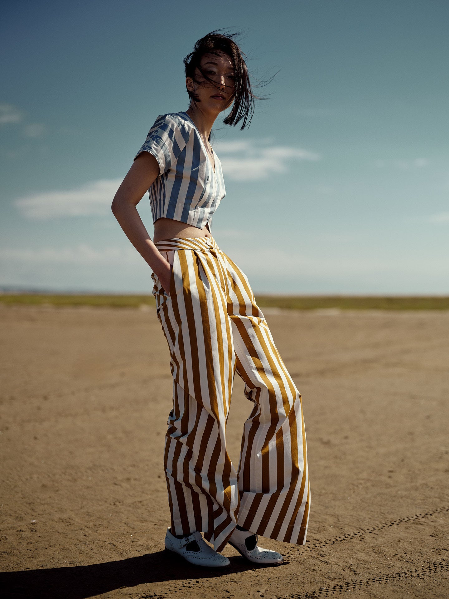 Model wears Loulou trousers in cotton poplin inspired by 1970s style by Thierry Colson