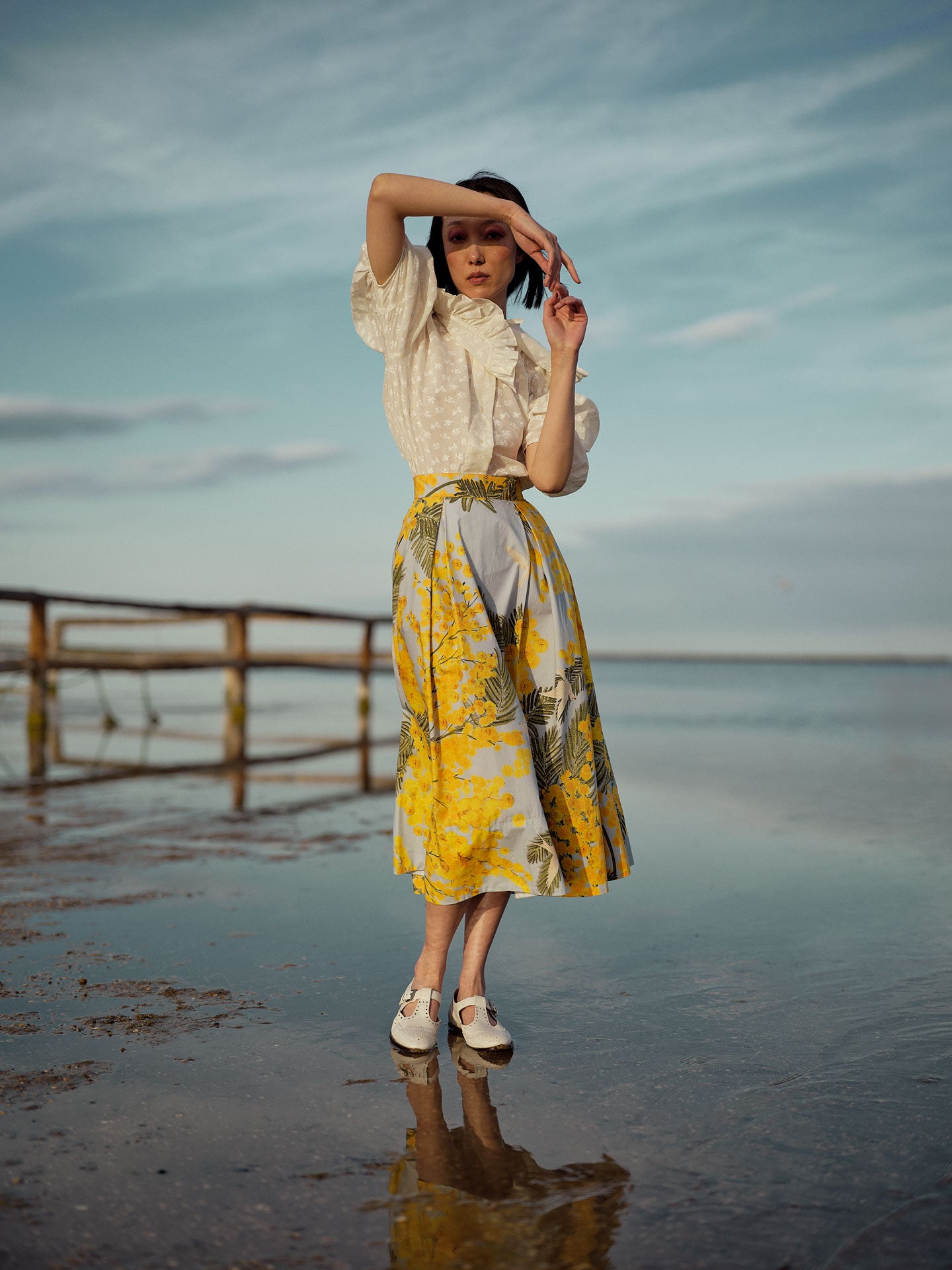 Side view of Wynona skirt in yellow and storm blue cotton poplin with Garden of Eden print, designed to create a slender silhouette. photographed by Stephane Gautronneau for Thierry Colson Pre-Spring 2025 collection