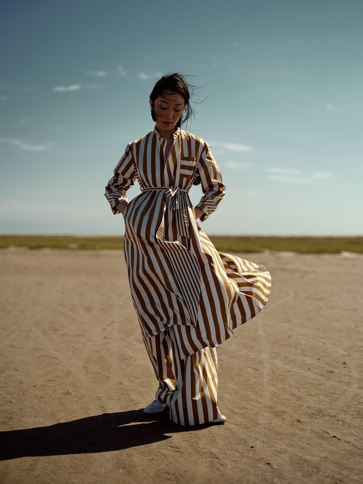 Model wearing Sacha dress in Tobacco with two-dimensional stripes.