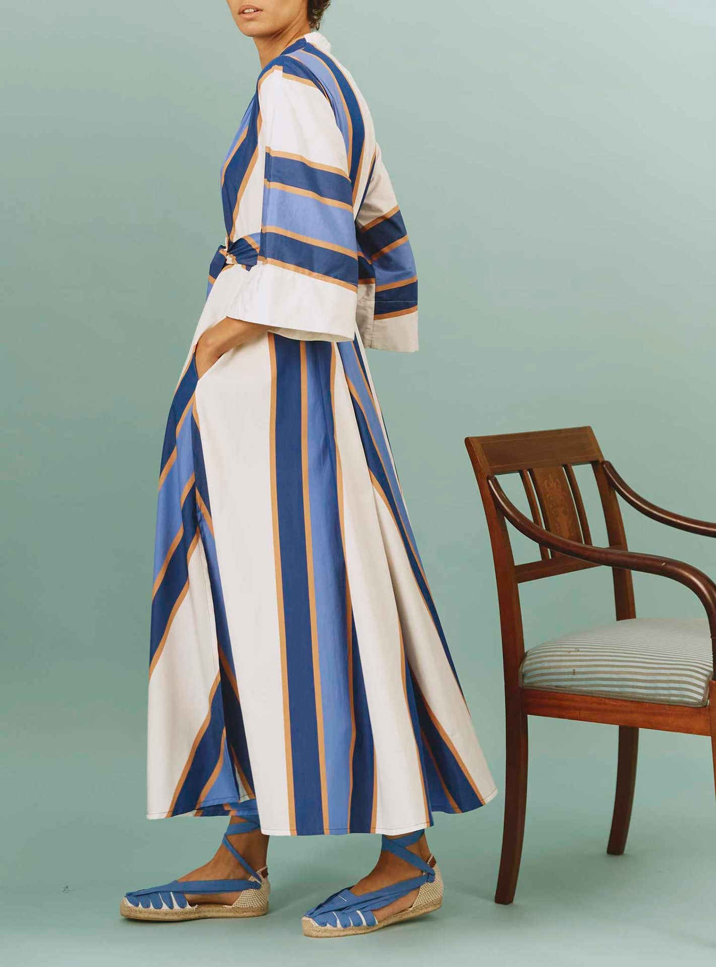 Side view of Almudena dress: Samarkand Stripes - Blue/Arancio by Thierry Colson | Spring/Summer 2024