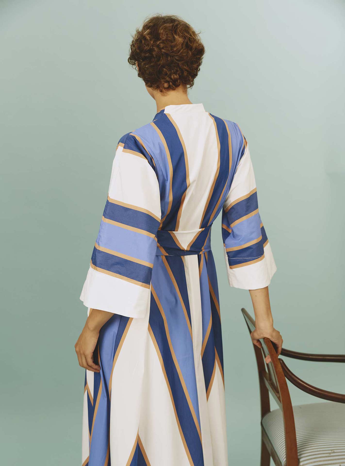 Back view of Almudena dress: Samarkand Stripes - Blue/Arancio by Thierry Colson | Spring/Summer 2024
