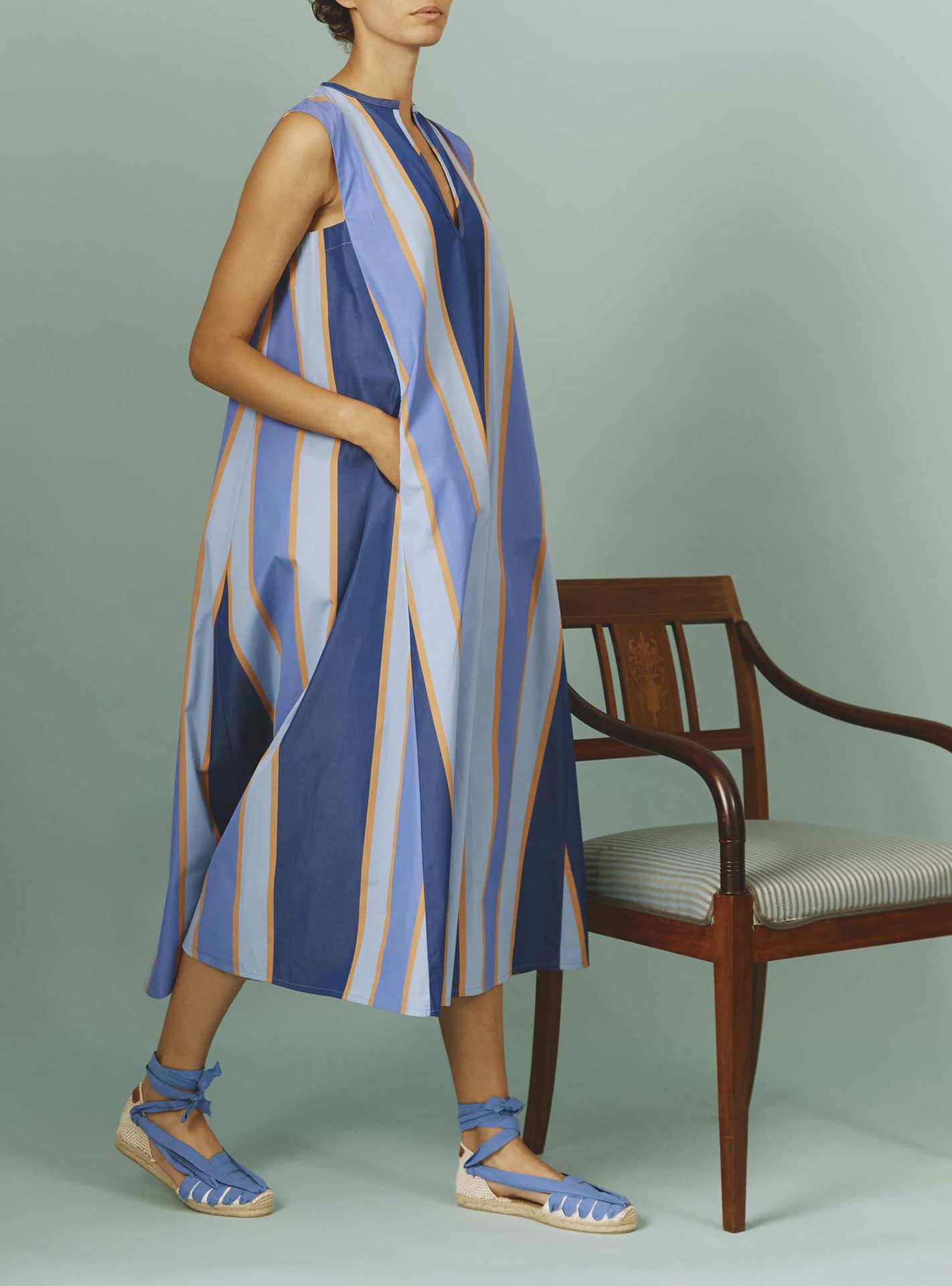 Side view of Apolonia Kaftan: Samarkand Stripes - Blue/Arancio | Spring/Summer 2024 by Thierry Colson - Hands in pockets