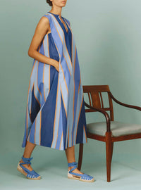 Side view of Apolonia Kaftan: Samarkand Stripes - Blue/Arancio | Spring/Summer 2024 by Thierry Colson - Hands in pockets