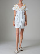 Front view without belt of BB dress in cabbage white poplin with hand-embroidered gingerbread and honey tones by Thierry Colson