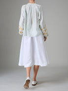 Back view of Guise Blouse in dobby cotton voile with Mediterranean-inspired hand embroidery by Thierry Colson