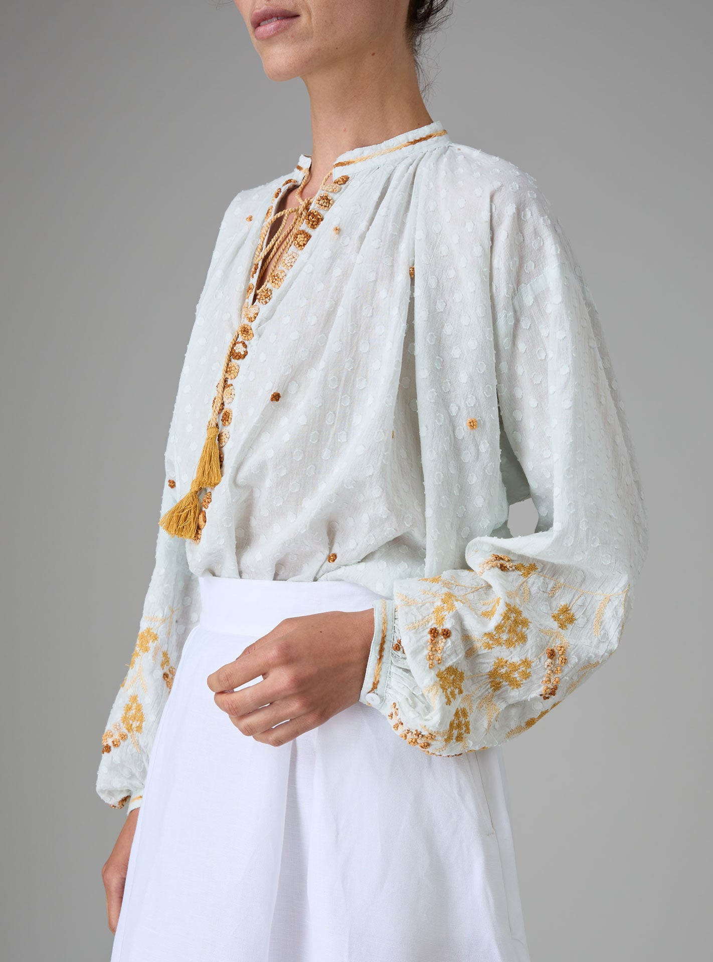 Side view of Guise Blouse in dobby cotton voile with Mediterranean-inspired hand embroidery by Thierry Colson