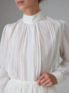 Detail view of Teresa Blouse in silk cotton with high collar and pintuck details by Thierry Colson