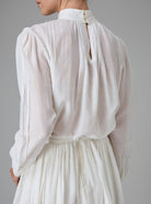 Back view of Teresa Blouse in silk cotton with high collar and pintuck details by Thierry Colson