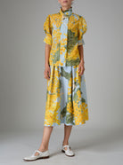 Large view of VITA blouse paired with wynona skirt. Gigot sleeves and ruffle collar in yellow and storm blue digitally printed cotton voile, inspired by French Riviera mimosa gardens. Thierry Colson collection