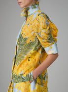 Side view of VITA blouse with Gigot sleeves and ruffle collar in yellow and storm blue digitally printed cotton voile, inspired by French Riviera mimosa gardens. Thierry Colson collection