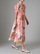 Side view of VENETIA dress with frilled collar and Gigot sleeves, crafted in pink and off-white Italian poplin with Garden of Eden print for Pre-Spring 2025 by Thierry Colson