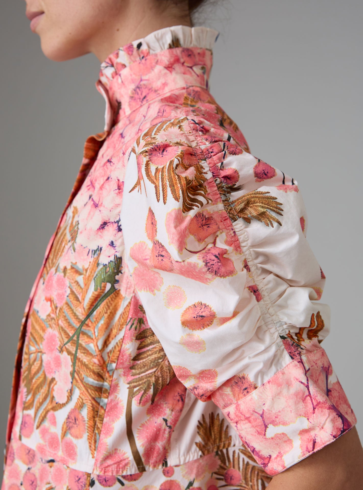 Sleeve Detail view of VENETIA dress with frilled collar and Gigot sleeves, crafted in pink and off-white Italian poplin with Garden of Eden print for Pre-Spring 2025 by Thierry Colson