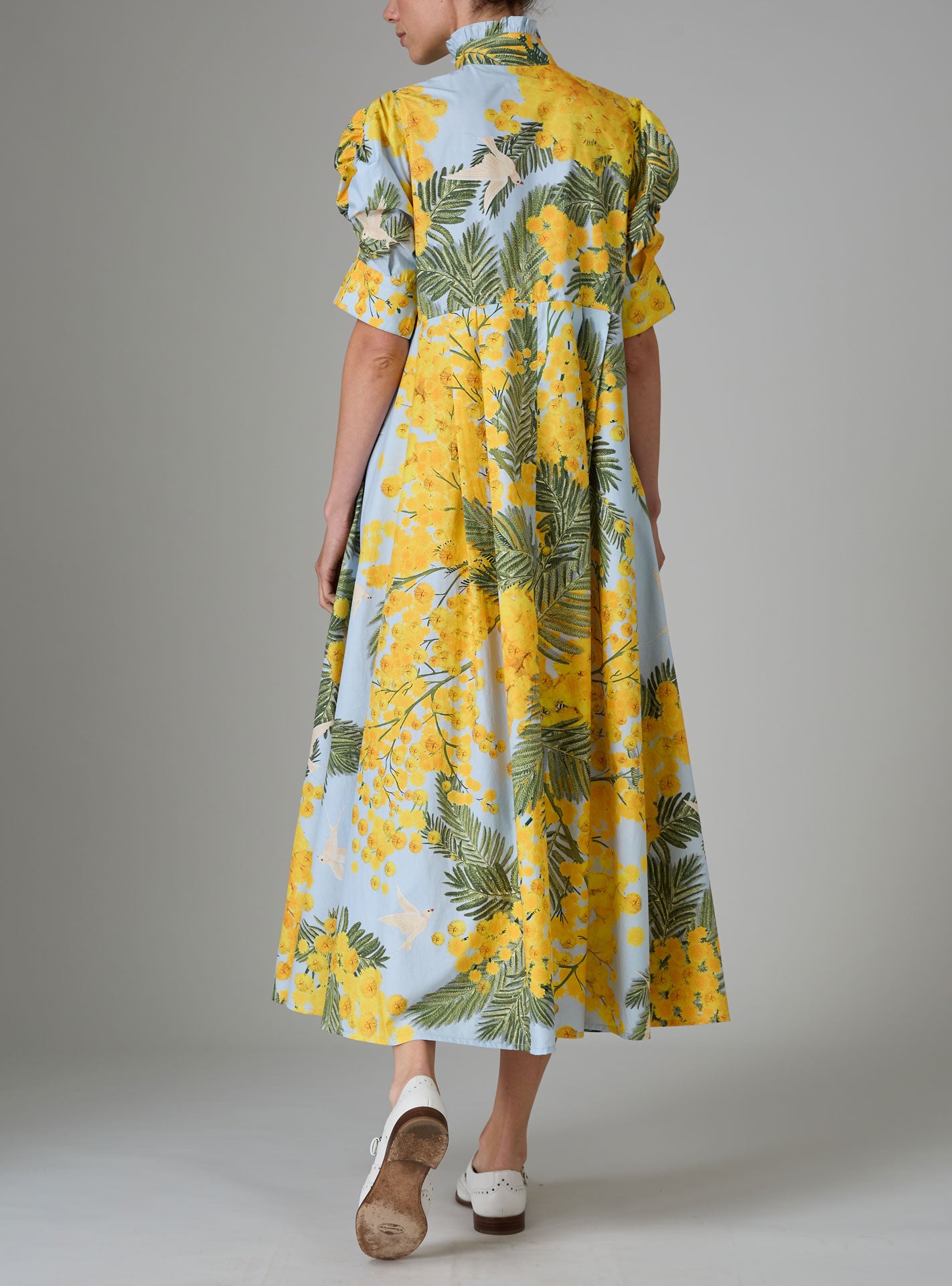 Back view of VENETIA dress in yellow and storm blue with frilled collar and Gigot sleeves by Thierry Colson