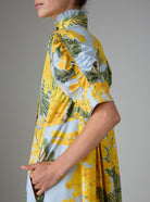 Sleeve detail of VENETIA dress in yellow and storm blue with frilled collar and Gigot sleeves by Thierry Colson