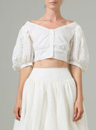 White off-shoulder top and skirt set on a neutral background