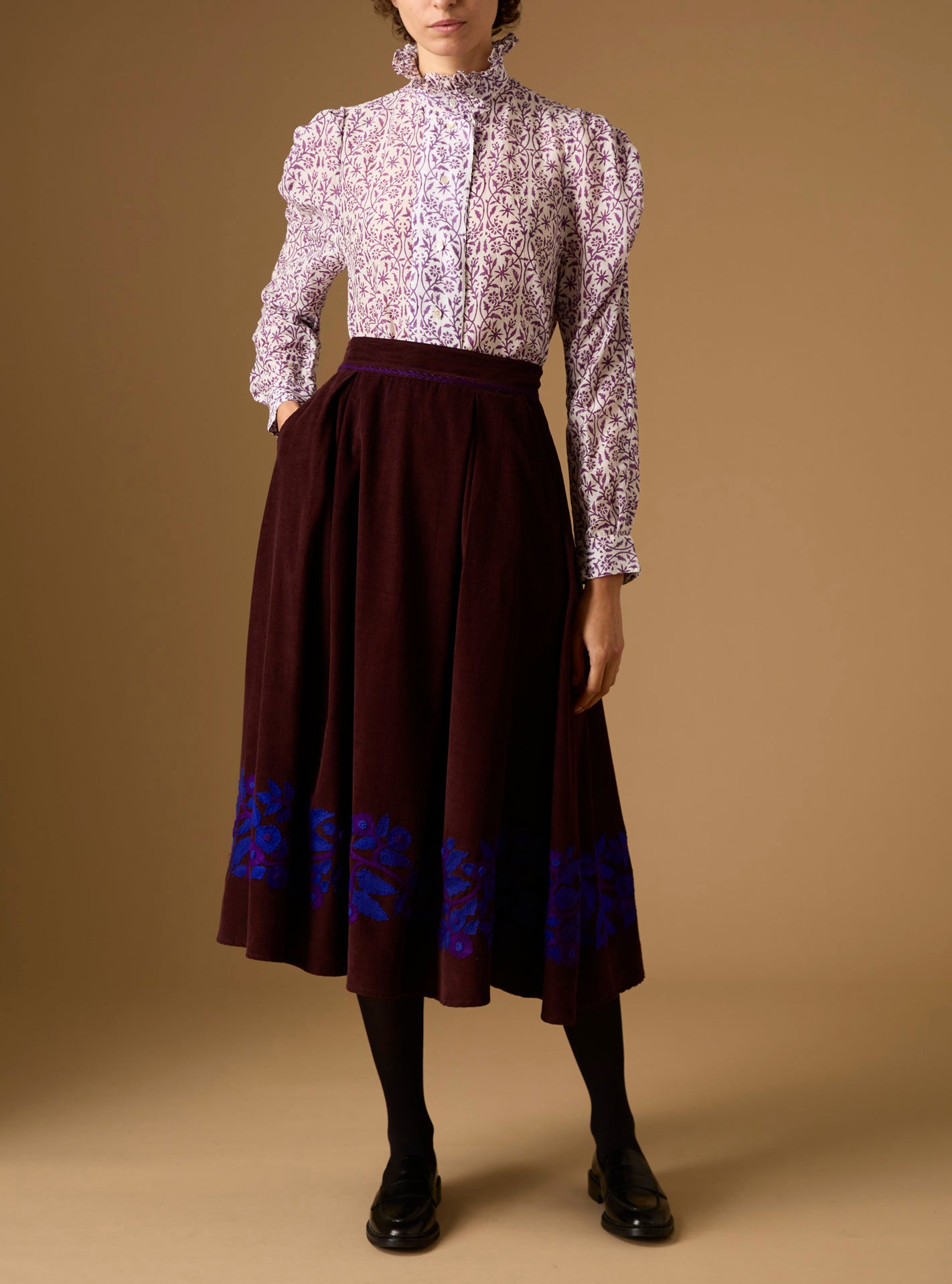 Front view of Wind Magic Purple Blouse with Wynona Skirt - Paper Cut Print by Thierry Colson 